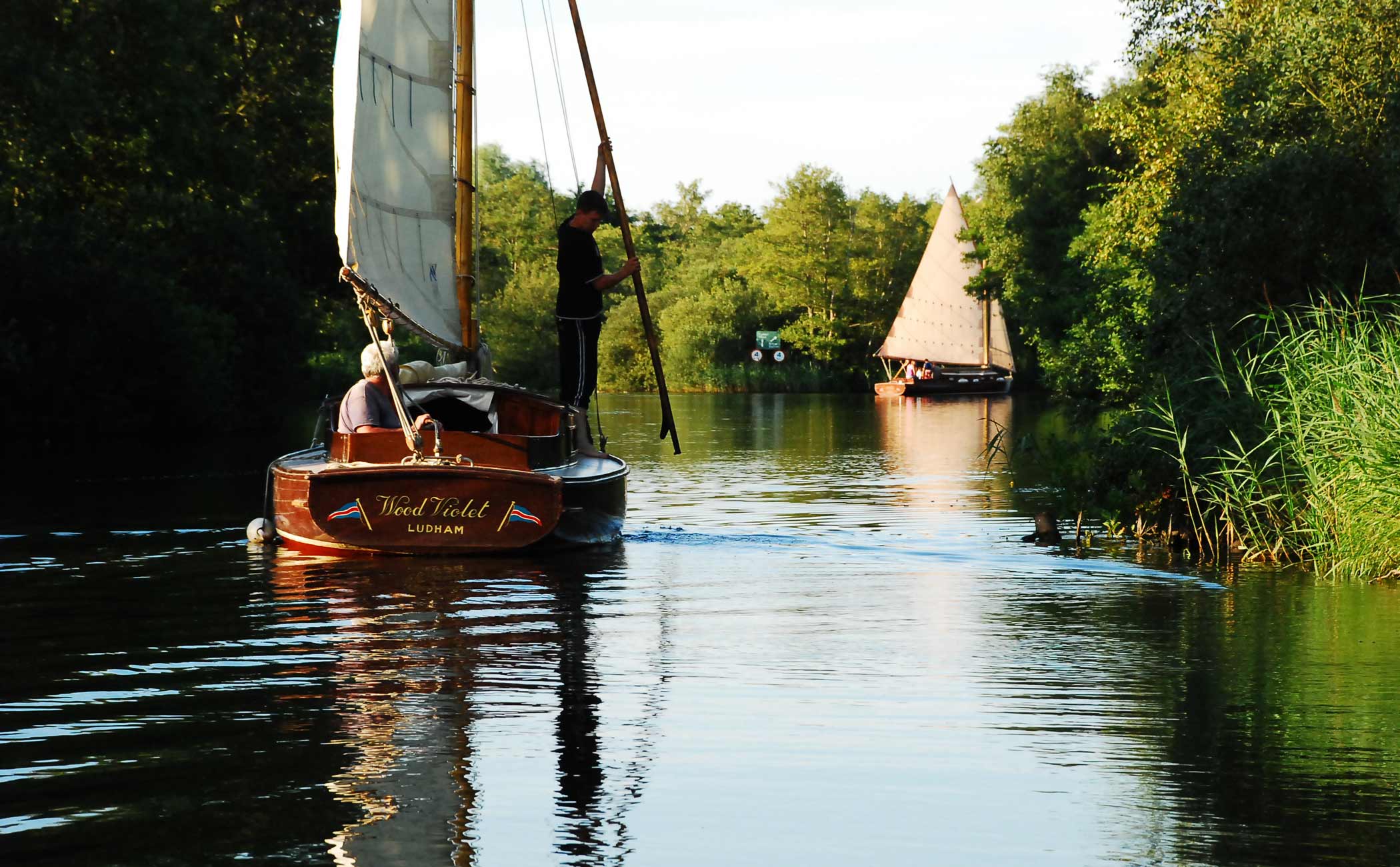 A Wood class cabin yacht sailing on the Norfolk Broads