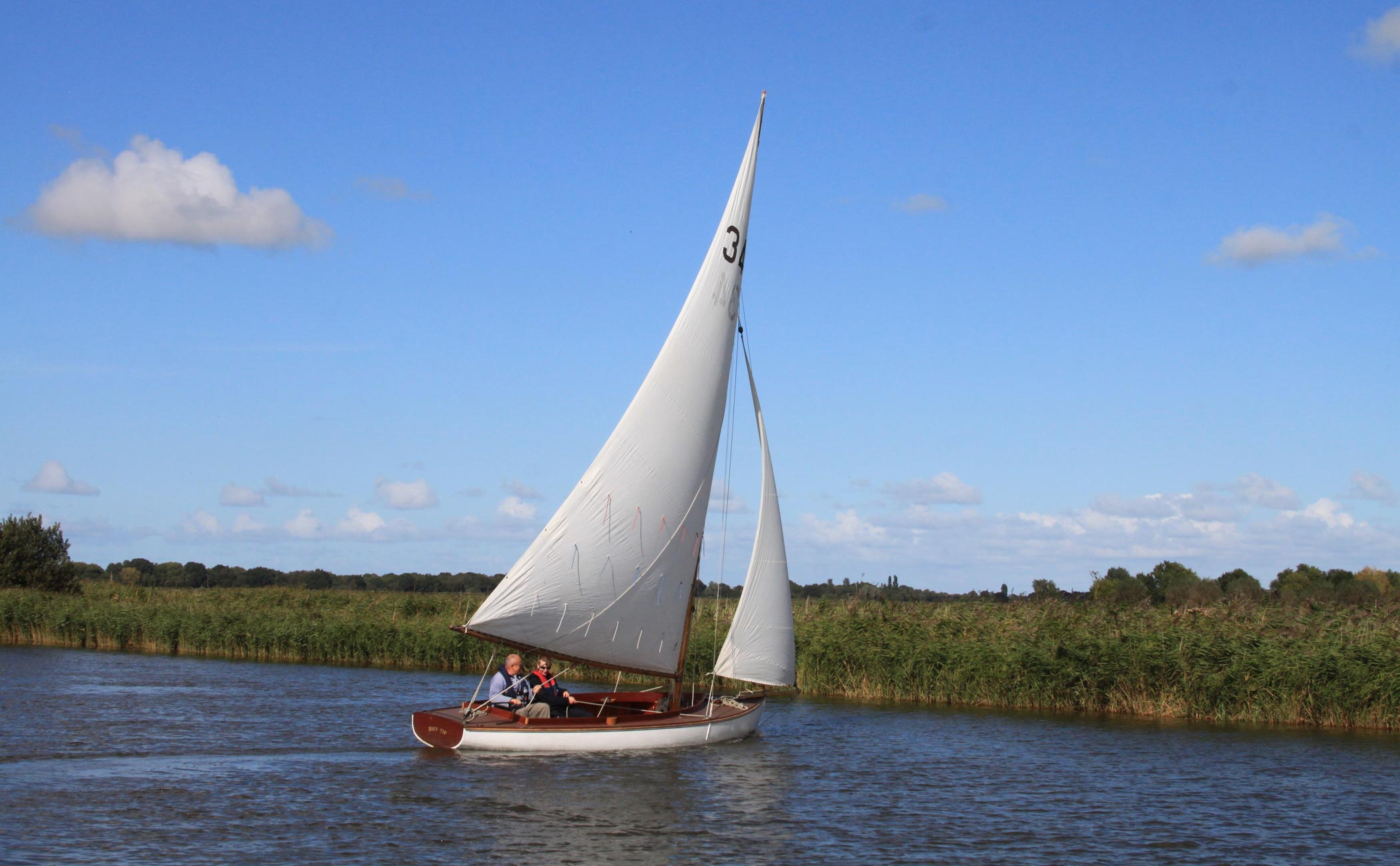 Traditional wooden half-decker Buff Tip sailing on the Norfolk Broads